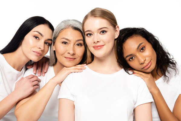 Group of diverse women of different ages and races wearing white t-shirts