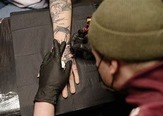 Tattoo being applied on hand