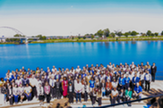 Group of people posing in front of a river