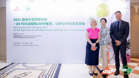 FDA China Office staff in front of workshop banner
