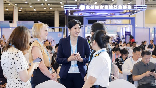 Sarah McMullen conversing with Suzhou regulators