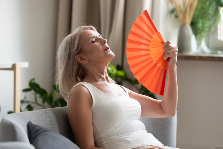 Older woman fanning herself