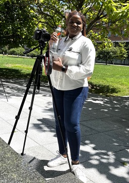 Marivon Sama, OCE communications specialist, with camera and tripod on FDA campus