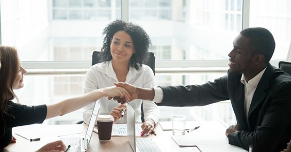 diverse business persons in meeting with handshake