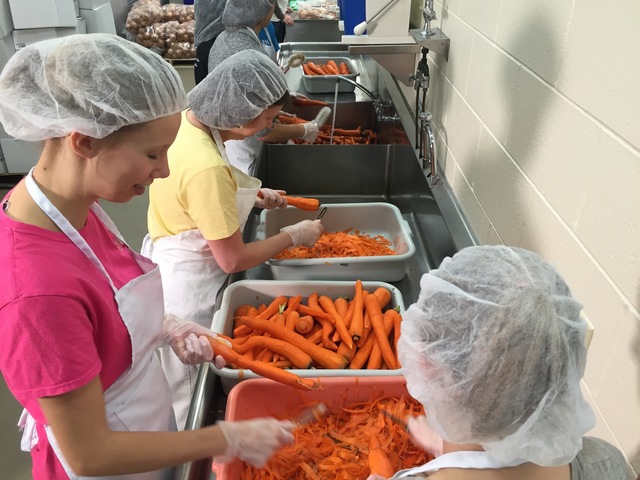 Students chopping carrots