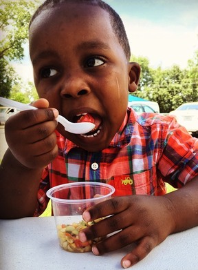 Boy eating healthy food at Head Start Program
