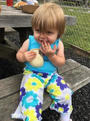 Preschool girl eating summer meal