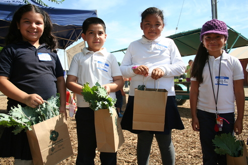 Kids holding produce bags