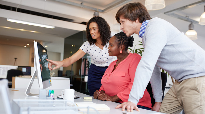team looking at the computer