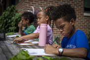 Kids writing in garden