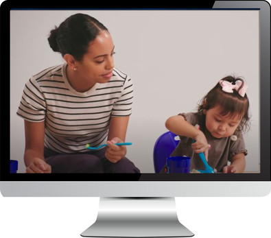 Computer monitor displaying video of childcare provider and toddler eating together
