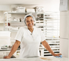 school nutrition professional smiling in the school kitchen