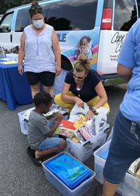 Boy picking out books at the Family Outreach Center Bookmobile. Courtesy Photo