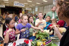 Students in school cafeteria reaching for produce
