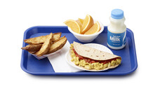 School meal tray with a breakfast taco, potato wedges, orange slices, and milk 