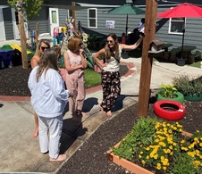 USDA FNS Administrator Long at an early childhood center with flower beds and picnic tables.