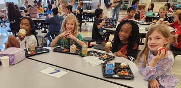 Students enjoying lunch in the cafeteria. 