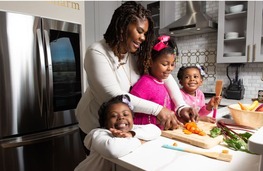 Dr. Cotwright with her children in the kitchen. 