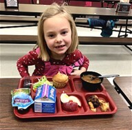 Girl eating school lunch at Phillipsburg School District