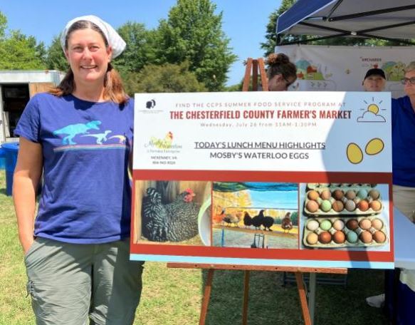 A producer next to a poster about information about their local eggs. 