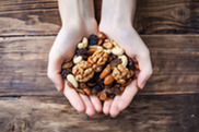 hands holding fruit and nut mix