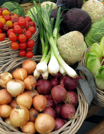 Bundle of potatoes, onions, leeks, tomatoes, and other vegetables.