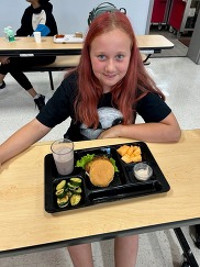 Child with fishcake sandwich