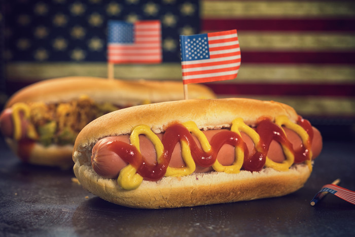 Hotdog in a bun with an American flag