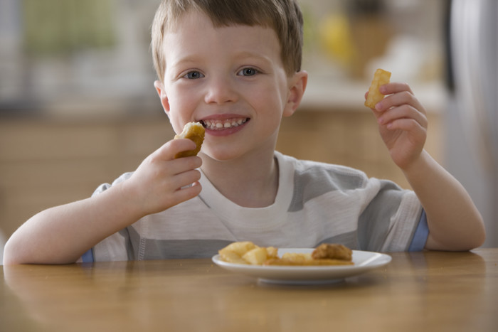Kid eating chicken nuggets