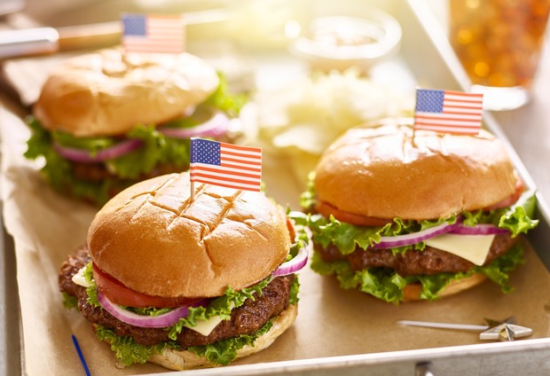 three hamburgers each with an American flag pin