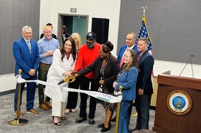 AgSec Rollins and others holding large scissors near ceremonial USDA ribbon