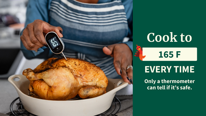Person taking the internal temperature of a cooked turkey with a food thermometer