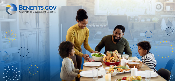 Young family sitting around dining table with a cooked turkey in the center