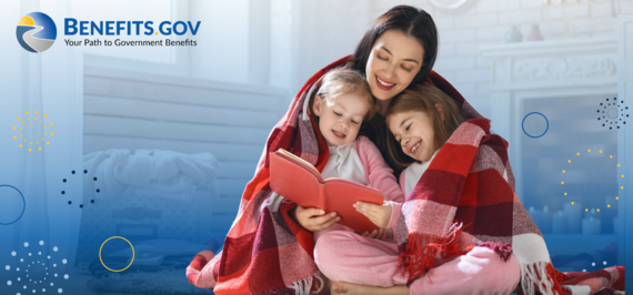 Mother huddles under blankets while reading with her two young daughters