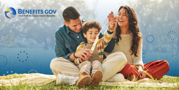 Young family blowing bubbles in a park