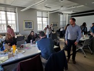 Several people working in a shared office space