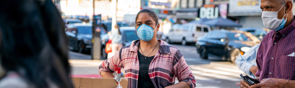 Woman and man wearing protective face masks during COVID-19