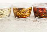 Leftover food in glass containers on a counter