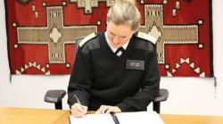 image of a public health officer signing a document