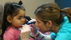 Photo of a child being examined by a dentist