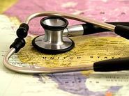 map of the us with a stethoscope lying on top of it