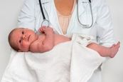 photo of a doctor holding an infant