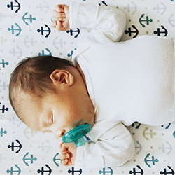 photo of an infant sleeping on their back