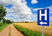 rural road with a hospital sign