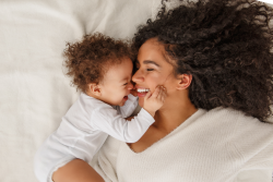 photo of a woman with her child on a bed