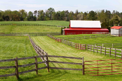 open farm land with red barn