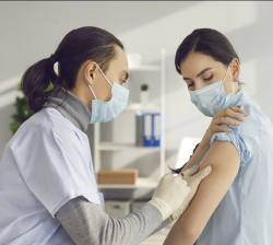 photo of a woman getting a vaccine from a medical professional