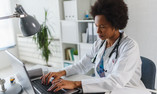 physician at laptop