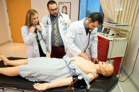 photo of medical students practicing on a dummy