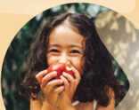 young girl eating apple